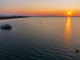 Naklejka premium Sunrise in Lignano Sabbiadoro seen from above. From the sea to the lagoon, the city of holidays