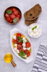 Tomato slices with cheese balls and spicy oil