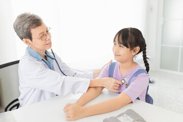 close up doctor, Asian doctor talk with children patient about disease symptom, doctor use stethoscope listening lung of patient, children health check up, happiness hospital