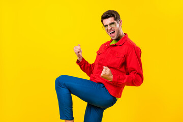 Photo of hooray young brunet guy yell wear red shirt eyewear isolated on yellow color background