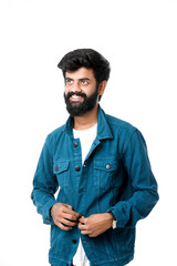 Young indian man wear jacket and giving expression over white background.