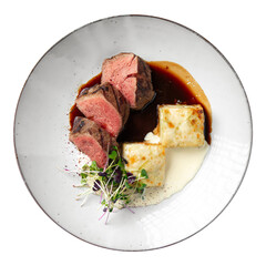 Isolated portion of sous-vide veal with potato gratin