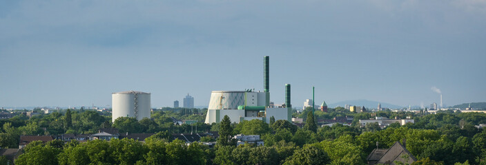 Industrial landscape panorama of Duisburg Wanheim, gas-fired power plant with steam accumulator and cooling tower, can also be operated with fuel oil in case of gas shortage, copy space
