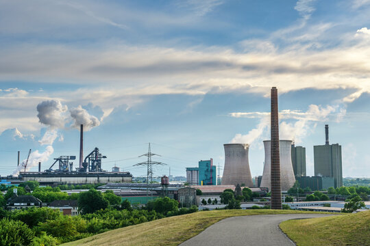 HKM, steelworks Krupp Mannesmann and power plant towers, heavy industry pollution using fossil energy in Duisburg, Germany, blue sky with clouds and copy space