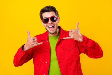 Photo of impressed young guy ask to call wear glasses red jacket isolated on yellow color background
