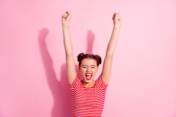 Photo of funky lucky woman wear cropped t-shirt creaming rising fists isolated pink color background