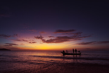 Travel by Thailand.  Colorful seascape with traditional fishing boat over beautiful sunset...