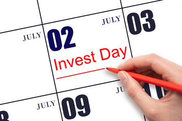 Hand drawing red line and writing the text Invest Day on calendar date July 2. Business and...