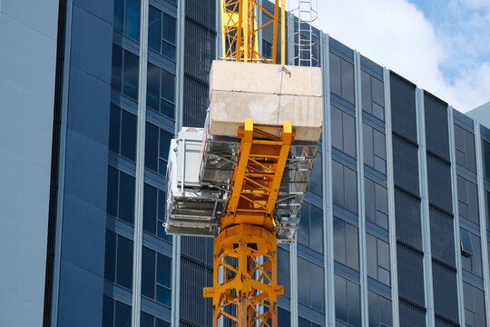 Construction crane in front of office building