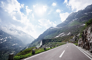 Asphalt road in Alp mountains. Road trip concept. Beautiful landscape.