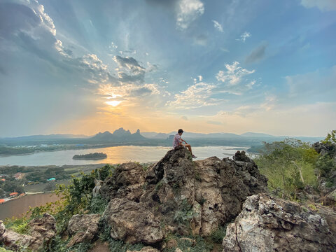 Adventure man with background of mountain view. Phu Sub Lek is hidden gem of Lopburi, Thailand to see view of Khao Jeen Lae with unseen sunset sky over the water from lake.