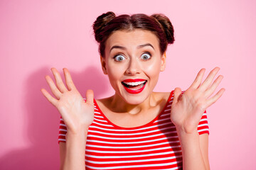 Portrait of impressed positive girl raise opened hands palms open mouth isolated on pink color background