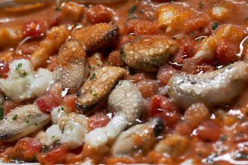 Frozen shrimps close-up. Dry freeze food with a minimum amount of water. Seafood delicacies. Selective focus Mixed frozen seafood in a plate Raw shrimp, mussels and scallops with drops of water