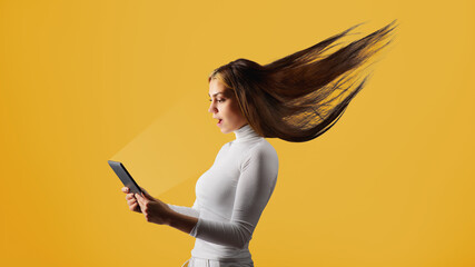 a young, attractive woman gets stormy content from the tablet. digital success concept.