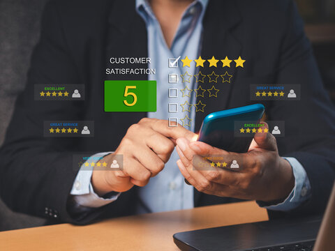 A Businessman using a smartphone gives the five-star icon a rating of very impressed for service