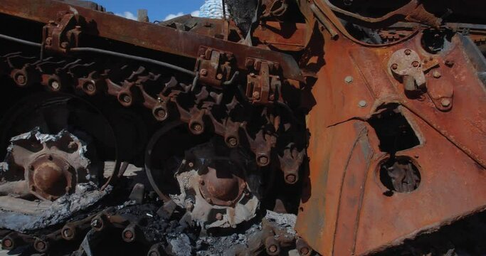 Close-up detailed tracking shot -  caterpillar  track of a burnt-out Russian tank t 72. Exibition in Kyiv on Sophia Square  Military vehicle destroyed by the explosion of Ukrainian artillery shelling