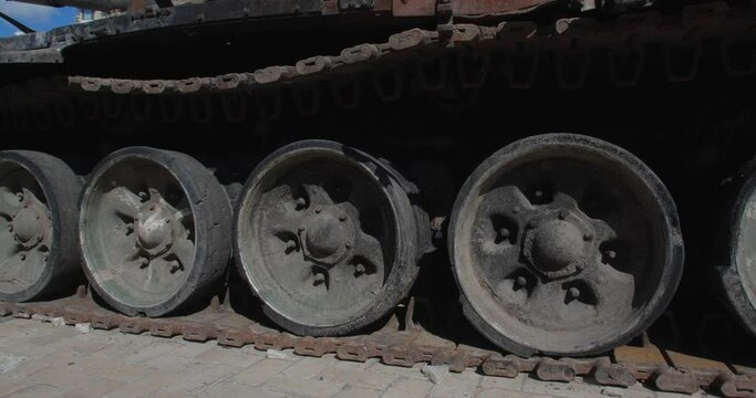 Close-up detailed tracking shot -  caterpillar  track of burnt-out Russian modern tank t 90. Exibition in Kyiv on Sophia Square Military vehicle destroyed by explosion of Ukrainian artillery shelling