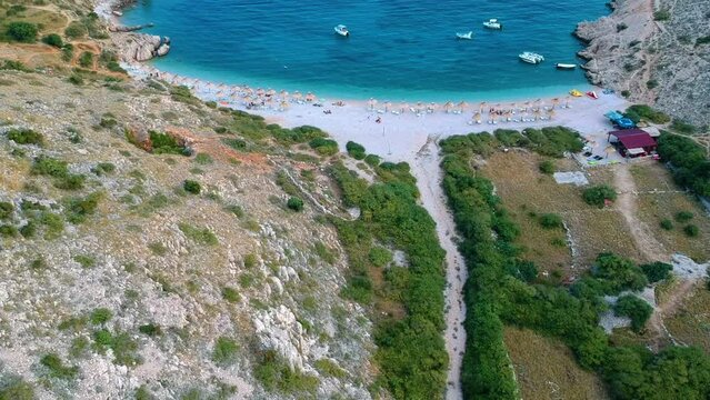 Aerial View Of Oprna Bay Beach With Umbrellas In Krk Island, Croatia. - tilt up