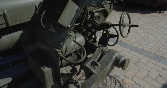 Tracking shot close up  of Russian howitzer destroyed by Ukrainian artillery shelling, exhibited on city street for demonstration. Detail of rusty burnt military weapon D-30