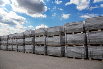 Pallets with gray paving slabs.