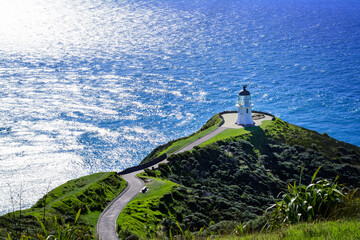 Stunning view at Cape Reinga Lighthouse and a winding path leading to it. Famous tourist attraction...