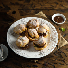 Homemade profiteroles with chocolate paste