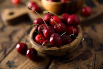 Fresh ripe cherries in a wooden bowl