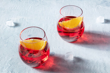 Campari and aperol cocktail with orange garnish, summer drinks with ice