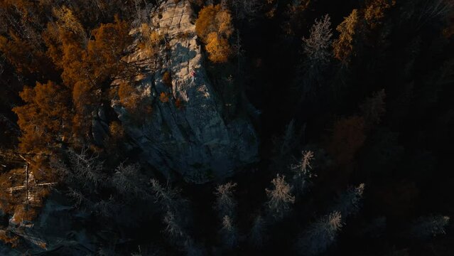 epic drone footage Aerial Magnificent view beautiful landscape with foliage woodson mighty Carpathians Mountains and clear blue sky. Hikers walking and resting on top of high cliff in forest