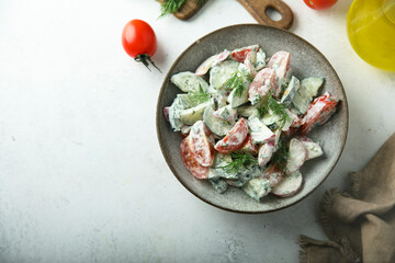 Homemade vegetable salad with tomato, cucumber and sour cream