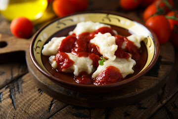 Traditional homemade dumplings with tomato sauce