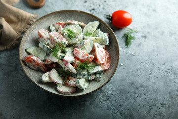 Homemade vegetable salad with tomato, cucumber and sour cream