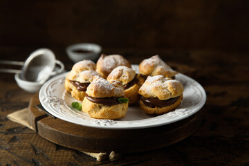 Homemade profiteroles with chocolate paste