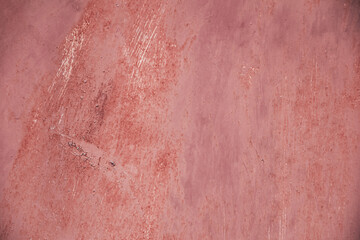 Aged rusty pink weathered background with cracks, scratches and spots or grunge rough surface metal backdrop.