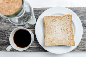 Sliced bread and a cup of coffee on the board