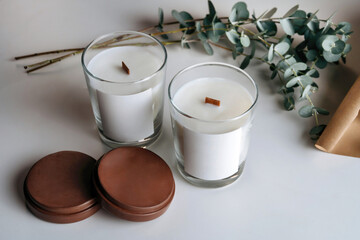 Handmade candle from paraffin and soy wax in glass with wooden wick and dry herbal.