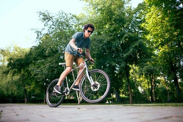 Fototapeta premium Cyclist riding in a city park.