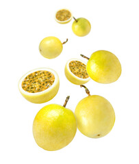 Yellow passion fruit with half sliced flying in the air isolated on white background.