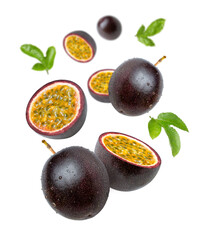 Purple passion fruit with half sliced flying in the air isolated on white background.