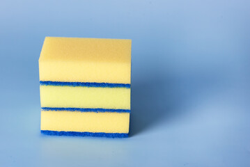 Set Yellow Dishwashing Ceaning Sponges on Blue Background Horizontal Copy Space