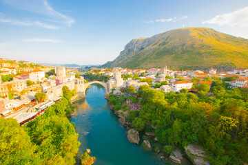 Fantastic Skyline of Mostar with the Mostar Bridge, houses and minarets, during sunny day....