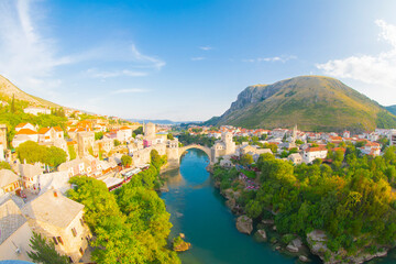 Fantastic Skyline of Mostar with the Mostar Bridge, houses and minarets, during sunny day....