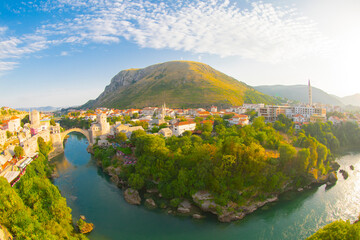 Fantastic Skyline of Mostar with the Mostar Bridge, houses and minarets, during sunny day....