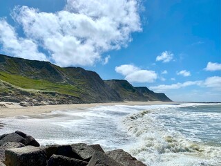 cliffs at the bovbjerg coast near ferring in denmark on a sunny day, coast, rocks and stones of the...