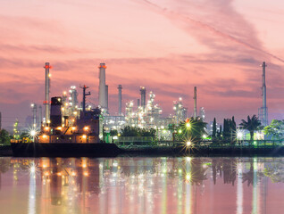 Fototapeta premium Morning view of Bangchak Phra Khanong Oil Refinery on the Chao Phraya River, Oil indutry refinery - factory with dramatic sunrise.