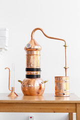 Distillation of lavender essential oil. Copper alambic in a Scandinavian interior.