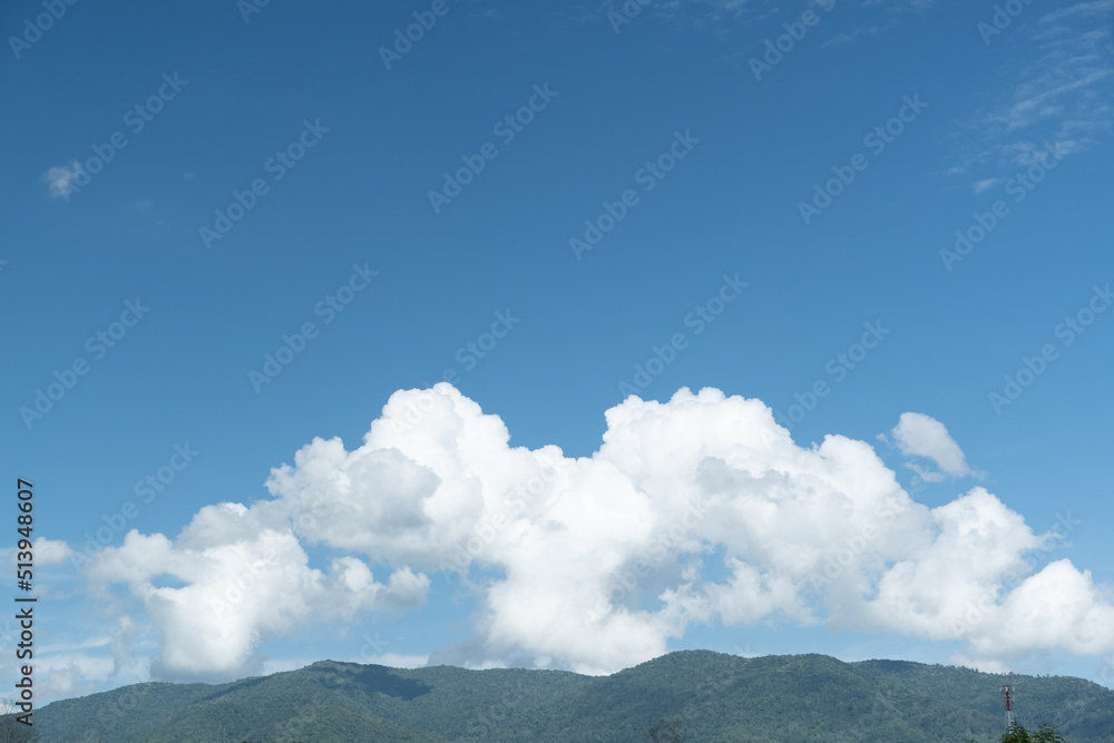 Wall mural the white clouds have a strange shape and moutain.the sky and the open space have mountains below.
