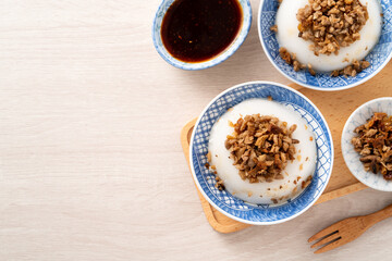 Taiwanese savory rice pudding Wa gui with chopped dried radish and soy sauce