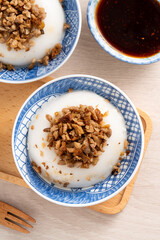 Taiwanese savory rice pudding Wa gui with chopped dried radish and soy sauce