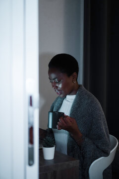 Working late - black woman finishing work at home